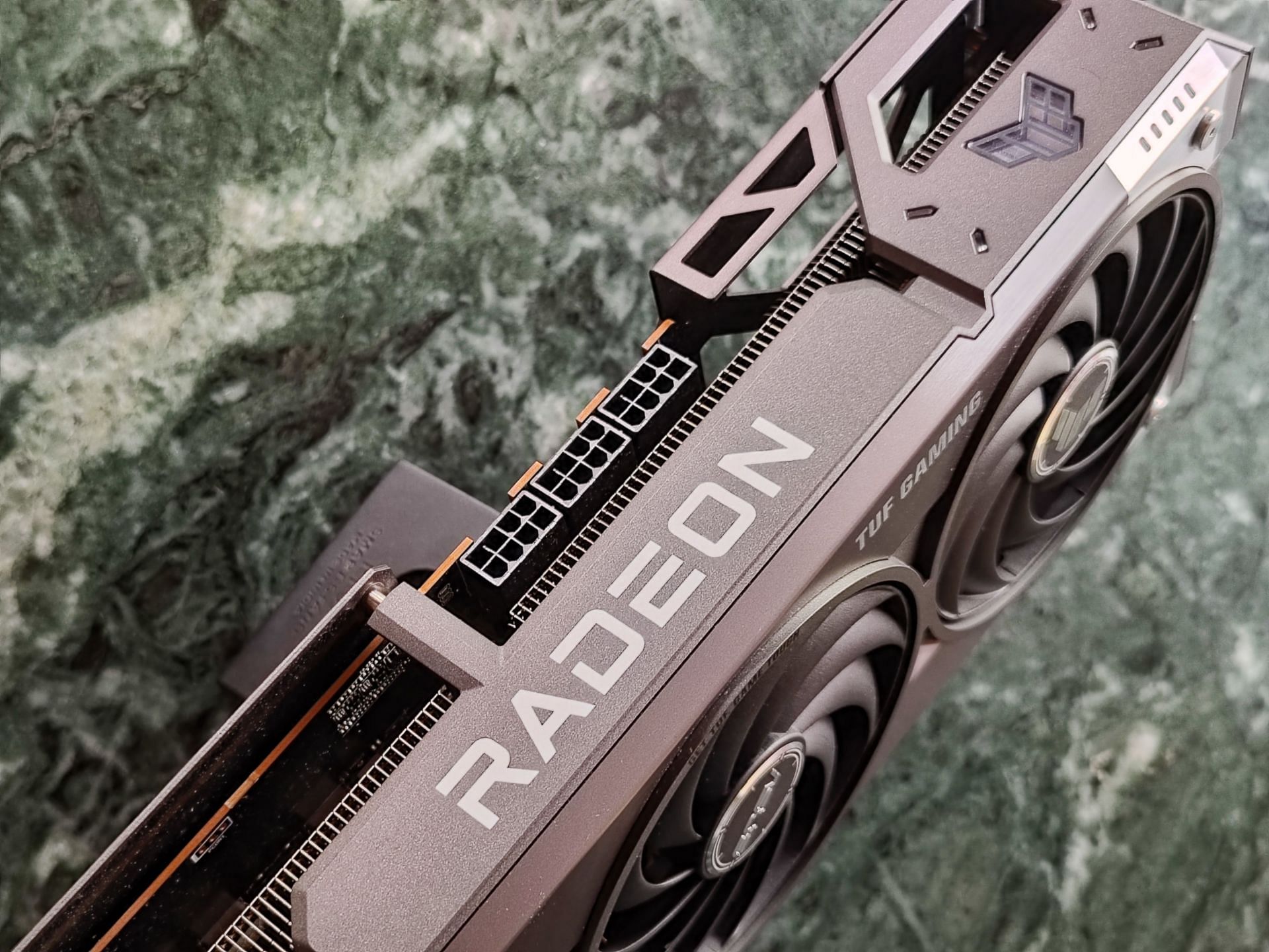The TUF Gaming RX 9070 XT draws power through three 8-pin connectors (Image via Sportskeeda)